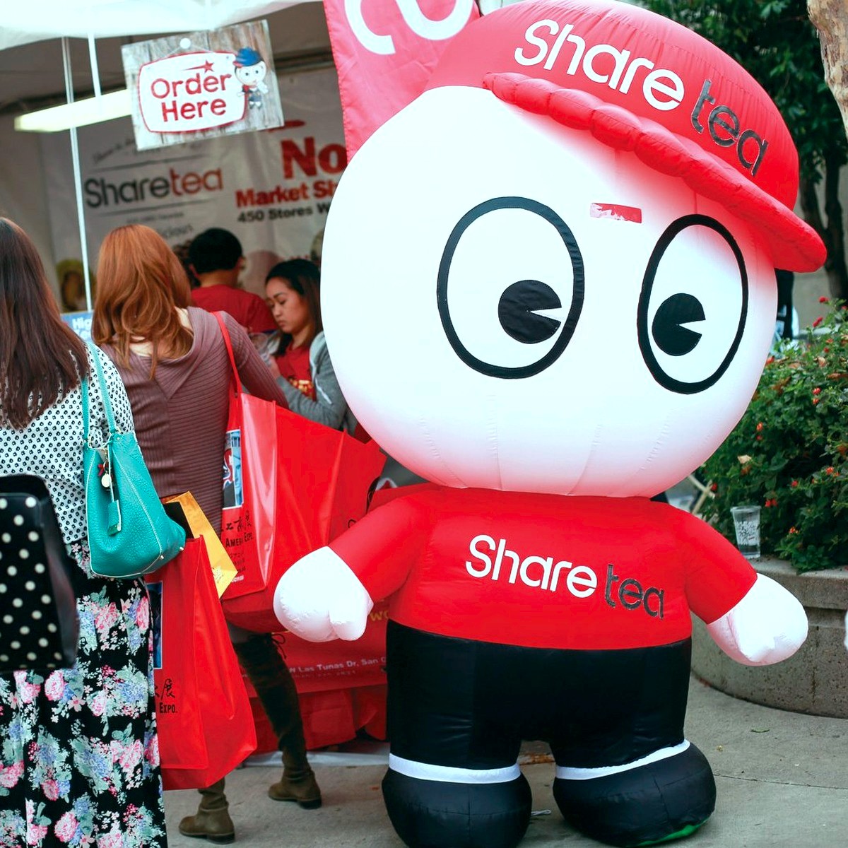 A vendor mascot greeting attendees